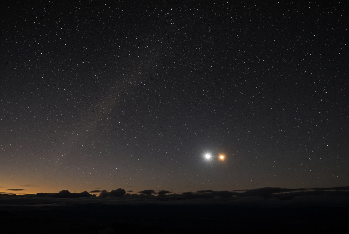 Photoreal evening sky · two bright planets close together above a dark horizon · Venus and Jupiter class conjunction atmosphere