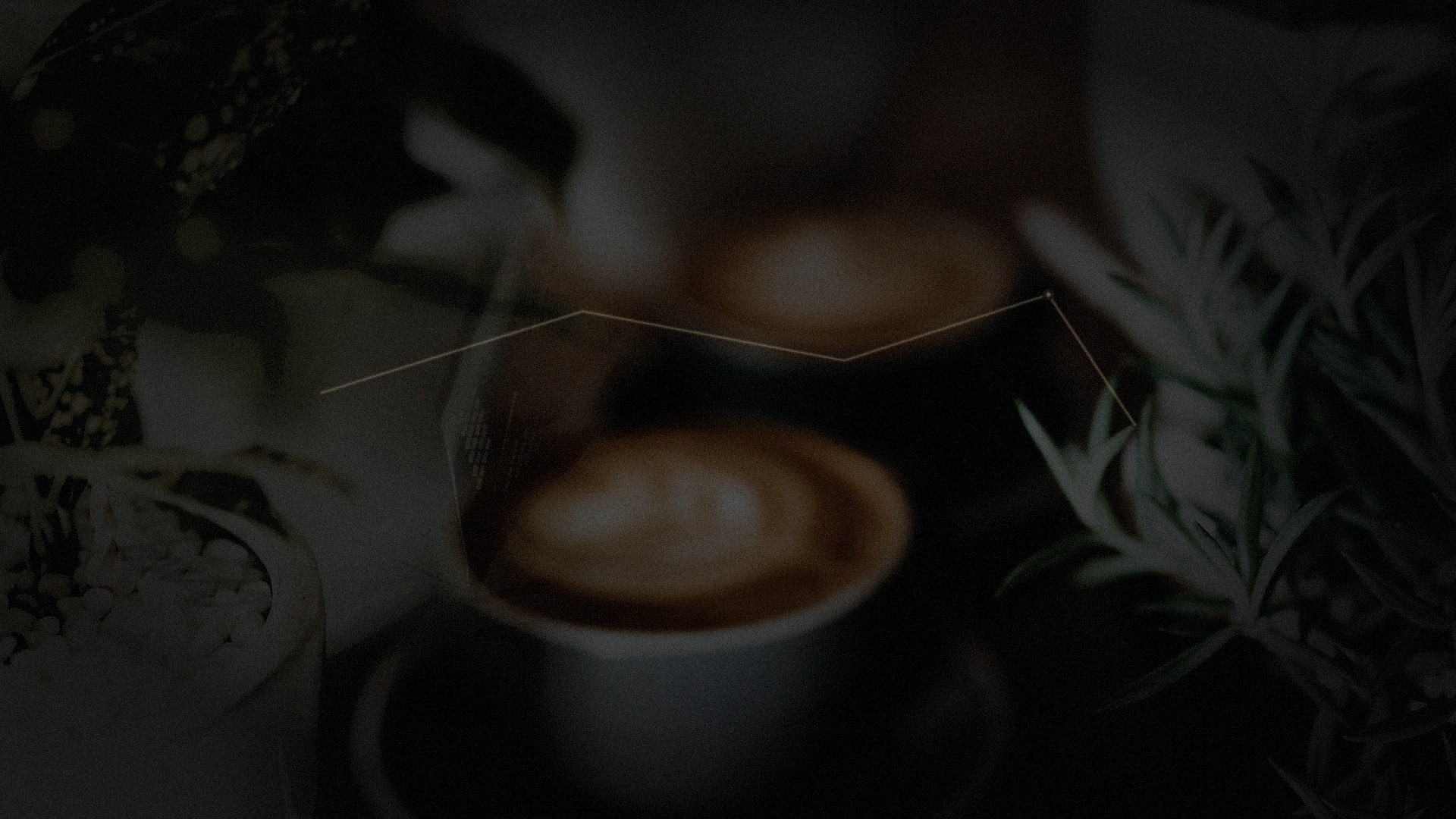 Night desk. A teacup, faint gold thread, papers at the edge of the light. No faces.