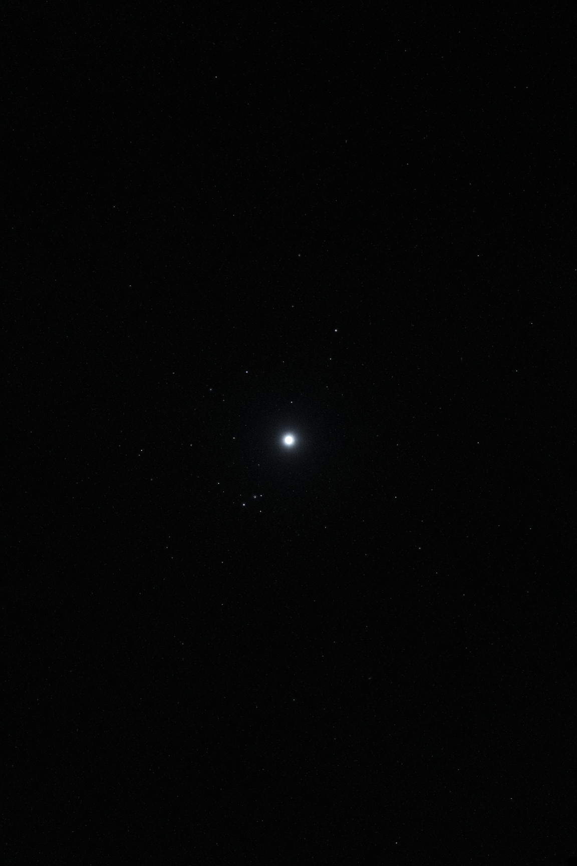 One sharp white-blue southern lamp in a black field. A faint sail of dim companions. Kappa Velorum as itself. No labels.