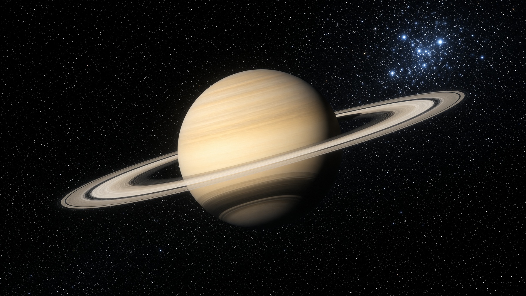 Saturn as a real ringed world. Pale gold, ice rings, a tight star cluster beyond.