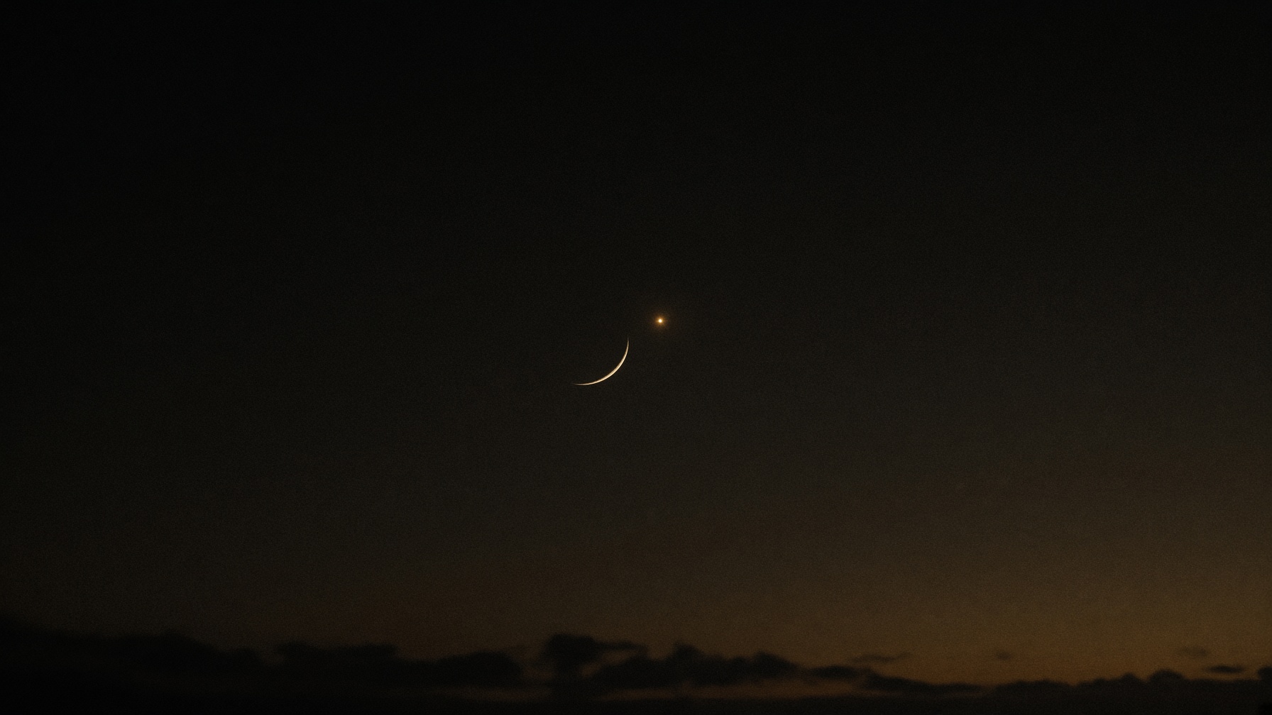 Thin crescent moon with Venus in the same twilight